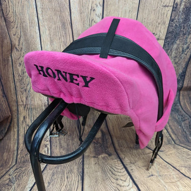 Embroidered storage saddle cover with girth tabs